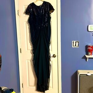 Long Navy gown with sequin detailing and stunning cut.